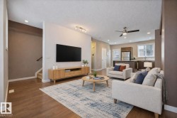 Living room featuring recessed lighting, stairs, dark wood-type flooring, a textured ceiling, and a ceiling fan - 