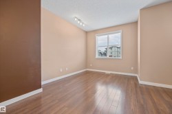 Empty room featuring a textured ceiling and dark wood-type flooring - 
