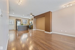 Unfurnished living room with dark wood-type flooring, a textured ceiling, a ceiling fan, recessed lighting, and track lighting - 