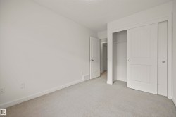 Unfurnished bedroom featuring carpet floors, a closet, and a textured ceiling - 