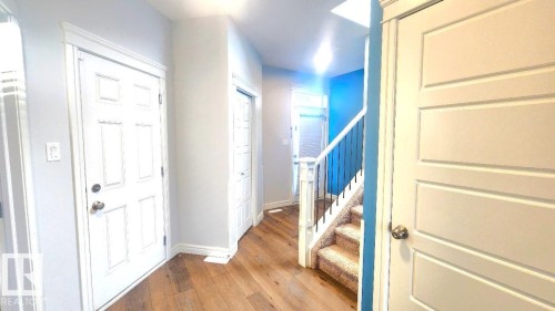Entrance foyer with stairway and light wood-style floors - 4610 Kinsella Landing Sw, Edmonton, AB - Indoor Photo Showing Other Room