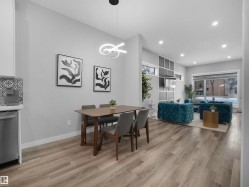 Dining room with light wood-style flooring, recessed lighting, and a chandelier - 