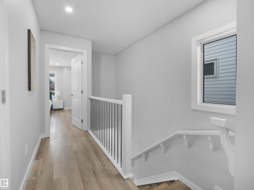 Hall featuring recessed lighting, light wood-type flooring, and an upstairs landing - 10911 159 Street, Edmonton, AB - Indoor Photo Showing Other Room