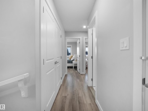Corridor with light wood-type flooring and recessed lighting - 10911 159 Street, Edmonton, AB - Indoor Photo Showing Other Room