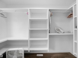 Walk in closet featuring dark wood-style floors - 