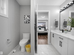 Bathroom featuring vanity, light marble finish floors, and ensuite bath - 