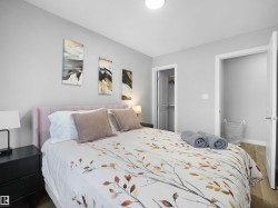 Bedroom with a spacious closet and wood finished floors - 