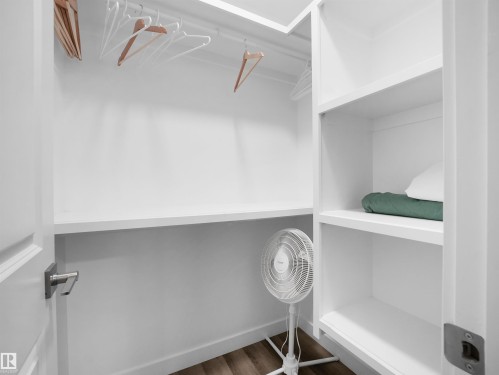 Walk in closet with dark wood finished floors - 10911 159 Street, Edmonton, AB - Indoor With Storage