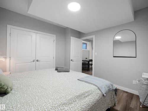 Bedroom with wood finished floors and a closet - 10911 159 Street, Edmonton, AB - Indoor Photo Showing Bedroom