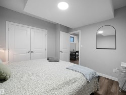 Bedroom with wood finished floors and a closet - 