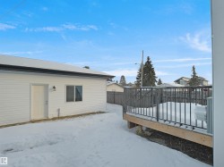 Snowy yard featuring a wooden deck - 