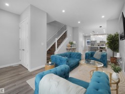 Living room with recessed lighting, light wood-type flooring, and stairway - 