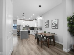 Dining room with light wood finished floors, recessed lighting, and a chandelier - 