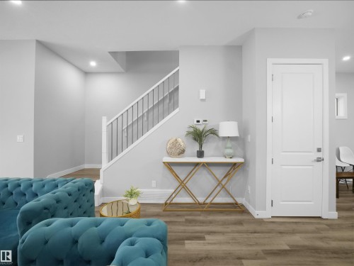 Sitting room featuring light wood-style floors, recessed lighting, and stairway - 10911 159 Street, Edmonton, AB - Indoor Photo Showing Other Room