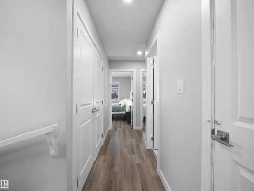 Hallway with dark wood-type flooring and recessed lighting - 10913 159 Street, Edmonton, AB - Indoor Photo Showing Other Room