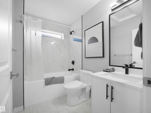 Bathroom with vanity, shower / bath combo, and light marble finish floors - 10913 159 Street, Edmonton, AB - Indoor Photo Showing Bathroom