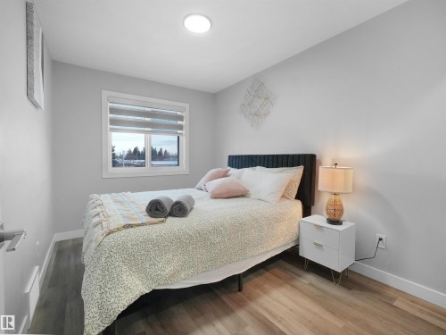 Bedroom featuring baseboards and wood finished floors - 10913 159 Street, Edmonton, AB - Indoor Photo Showing Bedroom