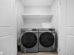 Washroom with washer and clothes dryer and wood finished floors - 