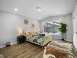 Bedroom with vaulted ceiling, wood finished floors, and recessed lighting - 