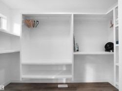 Spacious closet with dark wood-style flooring - 