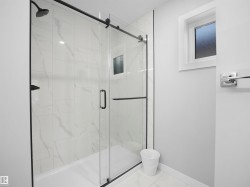 Bathroom featuring a marble finish shower - 