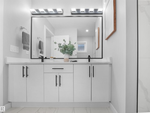 Bathroom featuring double vanity, recessed lighting, and light marble finish floors - 10913 159 Street, Edmonton, AB - Indoor Photo Showing Bathroom