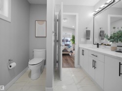 Bathroom with ensuite bathroom, double vanity, and light marble finish flooring - 
