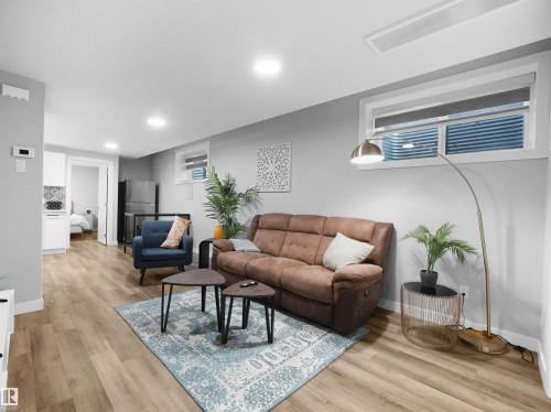 Legal basement suite Living area with light wood-type flooring and recessed lighting - 10913 159 Street, Edmonton, AB - Indoor Photo Showing Other Room