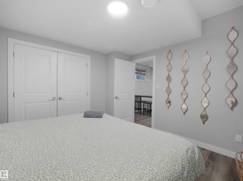 Legal basement suite Bedroom featuring wood finished floors and a closet - 10913 159 Street, Edmonton, AB - Indoor Photo Showing Bedroom