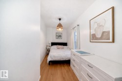 Bedroom featuring light wood-style floors and baseboards - 