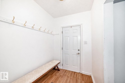 Mudroom with light wood finished floors and a textured ceiling - 10928 92 Street, Edmonton, AB - Indoor