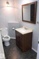 Half bathroom featuring vanity and dark tile patterned floors - 