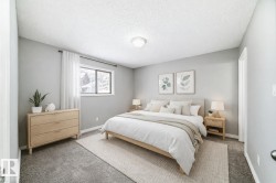 Carpeted bedroom featuring a textured ceiling and baseboards - 