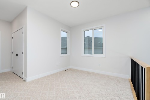 Spare room with light carpet and baseboards - 38 Astoria Place, Devon, AB - Indoor Photo Showing Other Room