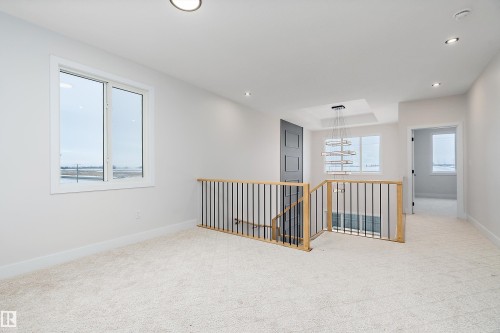 Unfurnished room featuring light colored carpet and recessed lighting - 38 Astoria Place, Devon, AB - Indoor Photo Showing Other Room
