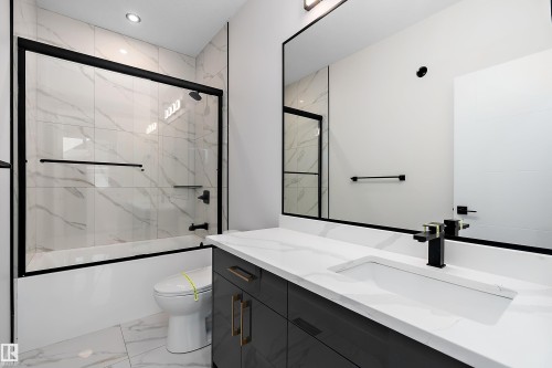 Bathroom with vanity, bath / shower combo with glass door, light marble finish flooring, and recessed lighting - 38 Astoria Place, Devon, AB - Indoor Photo Showing Bathroom