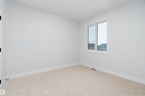 Empty room featuring baseboards and light colored carpet - 38 Astoria Place, Devon, AB - Indoor Photo Showing Other Room