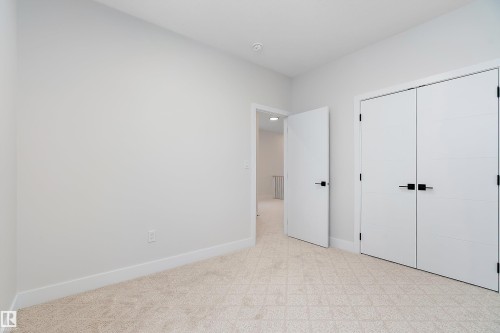 Unfurnished bedroom featuring light carpet and a closet - 38 Astoria Place, Devon, AB - Indoor Photo Showing Other Room