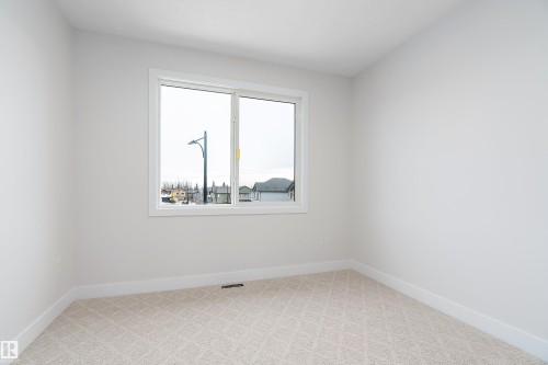 Empty room featuring light carpet and baseboards - 38 Astoria Place, Devon, AB - Indoor Photo Showing Other Room