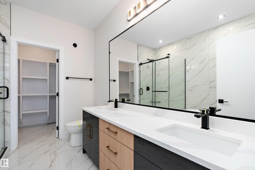 Bathroom with a spacious closet, light marble finish flooring, and a marble finish shower - 38 Astoria Place, Devon, AB - Indoor Photo Showing Bathroom