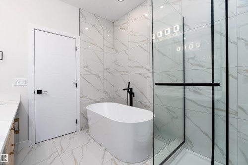 Full bathroom with tile walls, light marble finish flooring, vanity, a soaking tub, and a marble finish shower - 38 Astoria Place, Devon, AB - Indoor Photo Showing Bathroom