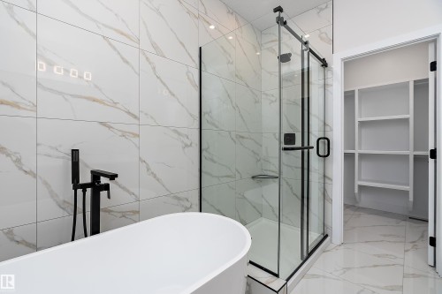 Bathroom featuring a marble finish shower, light marble finish flooring, and a freestanding bath - 38 Astoria Place, Devon, AB - Indoor Photo Showing Bathroom