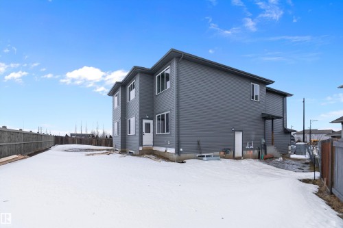 Snow covered property featuring a fenced backyard - 38 Astoria Place, Devon, AB - Outdoor