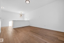 Unfurnished dining area featuring hardwood / wood-style floors and a chandelier - 