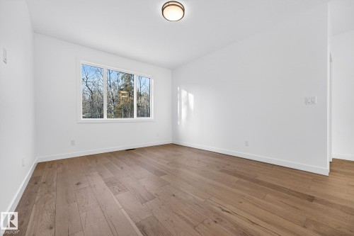 Spare room with baseboards and light wood finished floors - 132 Heron Point Close, Rural Wetaskiwin County, AB - Indoor Photo Showing Other Room