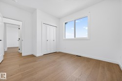 Unfurnished bedroom featuring light wood-style flooring and a closet - 