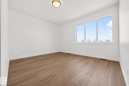Unfurnished room featuring light wood finished floors and baseboards - 132 Heron Point Close, Rural Wetaskiwin County, AB - Indoor Photo Showing Other Room