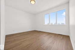 Unfurnished room featuring light wood finished floors and baseboards - 