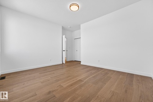 Unfurnished bedroom with light wood finished floors - 132 Heron Point Close, Rural Wetaskiwin County, AB - Indoor Photo Showing Other Room