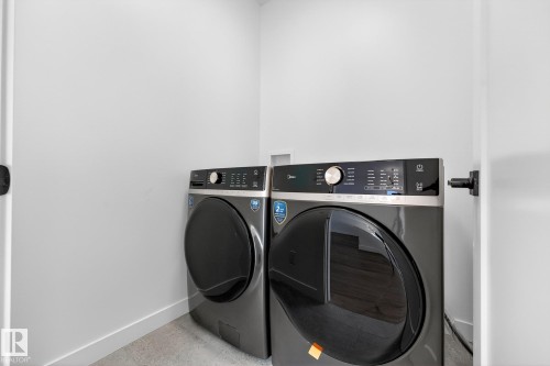 Laundry area featuring baseboards and washer and clothes dryer - 132 Heron Point Close, Rural Wetaskiwin County, AB - Indoor Photo Showing Laundry Room
